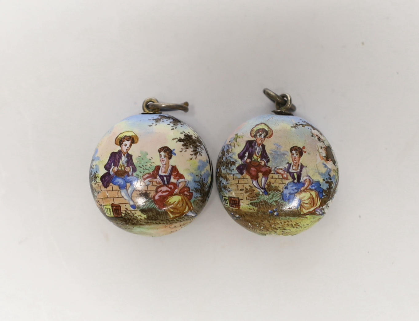 Two 19th century Viennese gilt white metal and enamel circular vinaigrettes, maker SG, enamel missing from one cover, diameter 22mm.